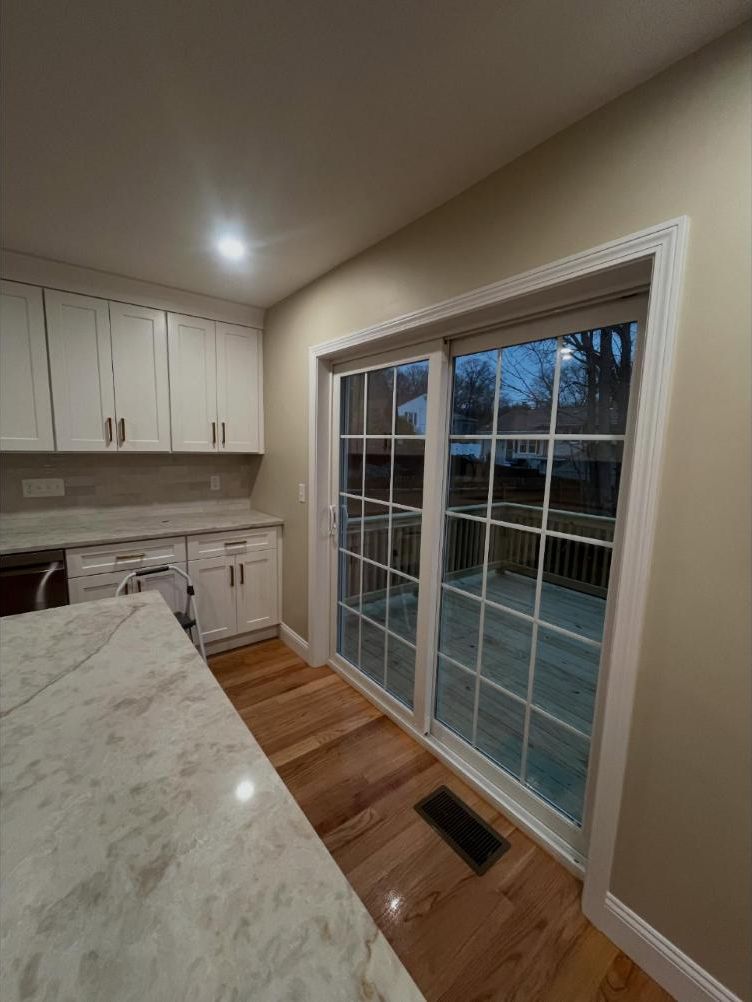 Kitchen with sliding patio doors and shiny hardwood