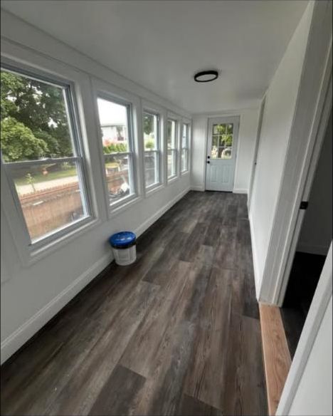 Long sunroom with a row of windows